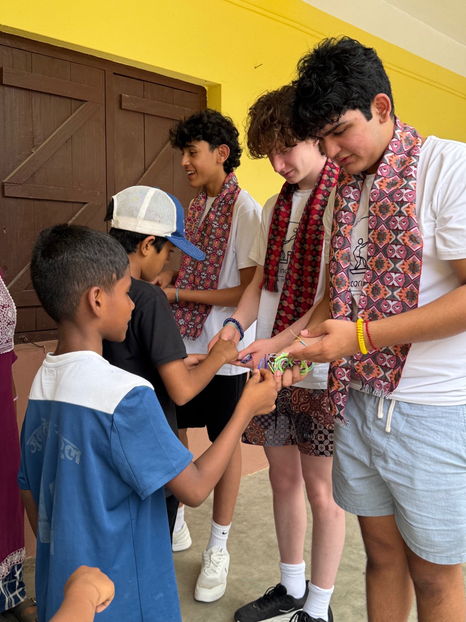 Students sharing handmade bracelets